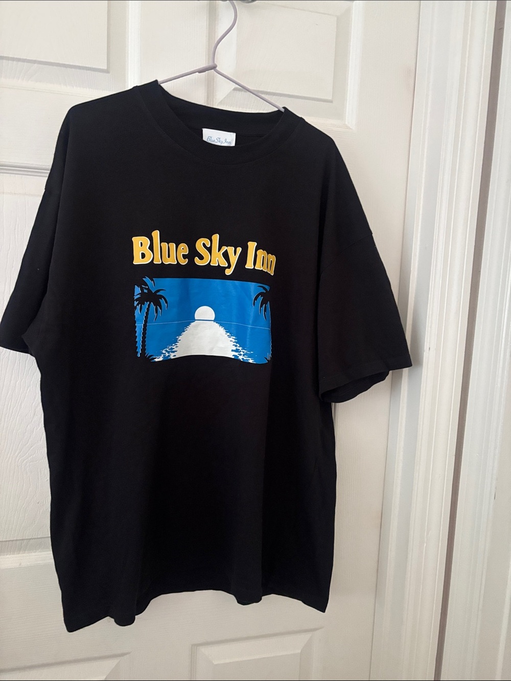 Blue Sky Black Tee with Yellow Logo and Blue Sunset Graphic